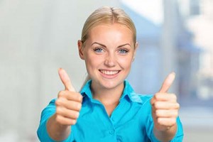 Happy young woman with thumbs up